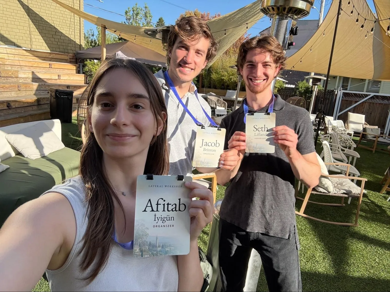 Afitab İyigün, Jacob Brinton and Seth Lifland holding their Lateral Workshop name badges
